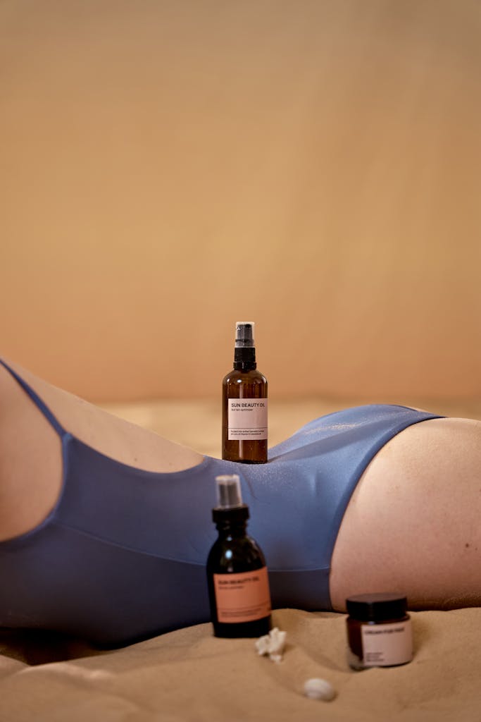 Skincare products displayed on a woman's body in a swimsuit.